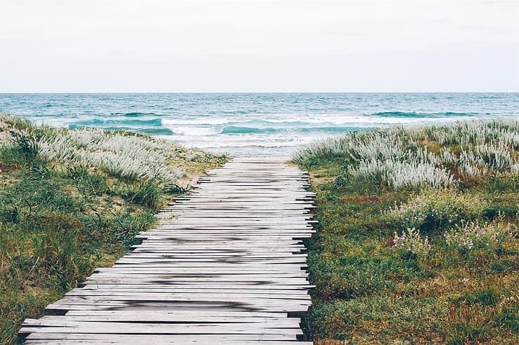 Beach with a long road of wood